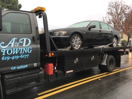 san diego towing A&D company flatbed tow truck with company logo and phone number 619-419-6177